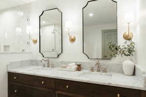 Bathroom with vanity and tiled shower