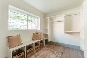 Spacious closet featuring light wood-type flooring