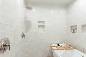 Bathroom with tile walls and shower with separate bathtub