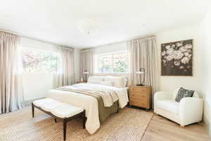 Bedroom with light hardwood / wood-style flooring