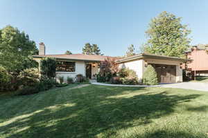 View of front facade with a garage and a front yard