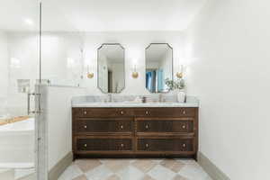 Bathroom featuring independent shower and bath and vanity