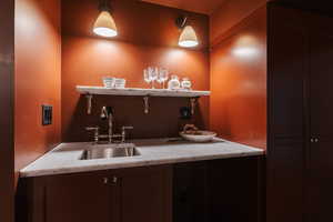 Clothes washing area featuring indoor wet bar