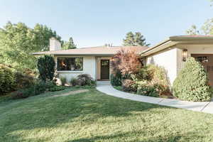 Ranch-style house with a front lawn