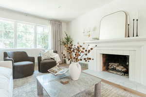 Living room with wood-type flooring and a tile fireplace