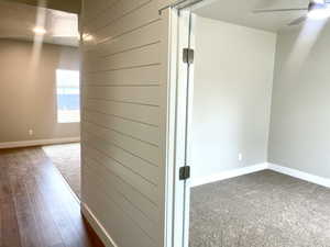 Corridor with a water view, dark hardwood / wood-style flooring, and a textured ceiling