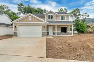 Craftsman-style home with a garage and covered porch