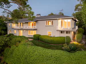 Back of home with balcony and deck