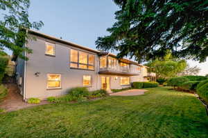 Back of home with balcony and deck