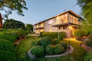 Back of home with balcony and deck