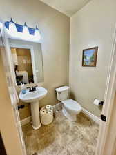 Bathroom featuring washer / dryer, toilet, and tile patterned flooring