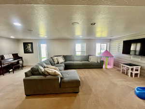 Living room featuring a textured ceiling and light colored carpet