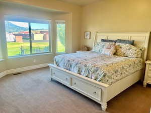 Bedroom featuring a mountain view and carpet flooring