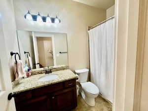 Bathroom with tile patterned floors, vanity, and toilet