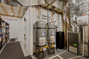 Utility room featuring strapped water heater