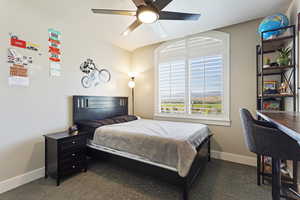 Carpeted bedroom featuring ceiling fan