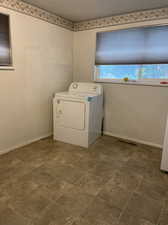 Laundry area with washer / dryer and tile patterned floors