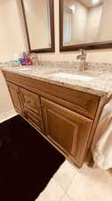 Bathroom with tile patterned floors and vanity