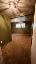 Empty room featuring carpet and a textured ceiling