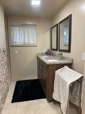 Bathroom featuring tile patterned floors and vanity