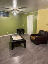 Living room featuring ceiling fan and hardwood / wood-style flooring