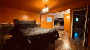 Bedroom with wood-type flooring and a closet