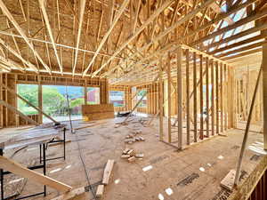 View from Entry to the back of the house featuring  a large greenroom with sliding glass door to covered back patio.