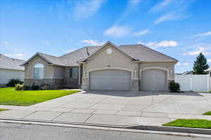 View of front facade with a garage and a front lawn