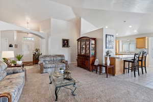 Living room featuring light carpet and lofted ceiling