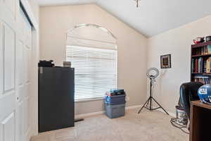 Interior space with carpet flooring and vaulted ceiling