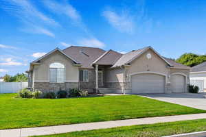 View of front of home with a front lawn and a garage