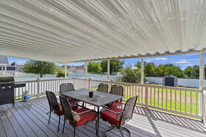 Wooden terrace with a storage unit and a yard