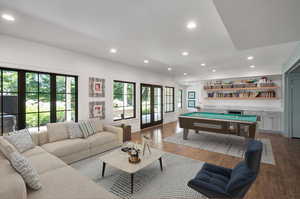 Basement Playroom with pool table, hardwood / wood-style floors, and french doors