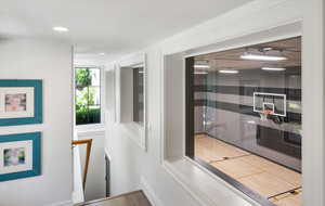 Hall featuring hardwood / wood-style flooring with views down to indoor basketball court