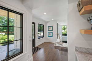 Basement Interior space featuring a wealth of natural light and dark wood-type flooring