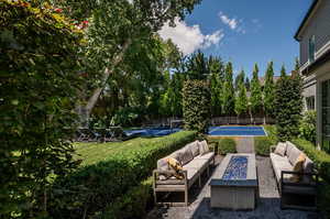 View of yard featuring an outdoor living space and fire pit