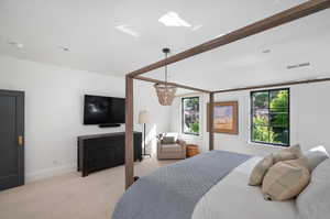 Bedroom featuring light colored carpet