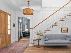 Foyer entrance featuring light hardwood / wood-style floors and crown molding