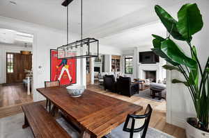 Dining room with plenty of natural light, light hardwood / wood-style floors, and ornamental molding