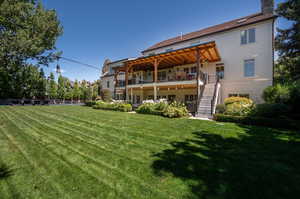 Rear view of property with a lawn