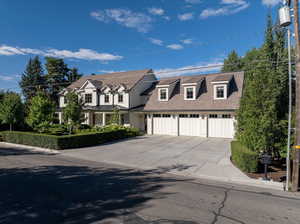 Cape cod-style house featuring a garage