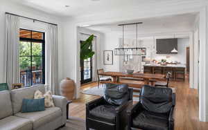 Living room featuring crown molding and light hardwood / wood-style flooring