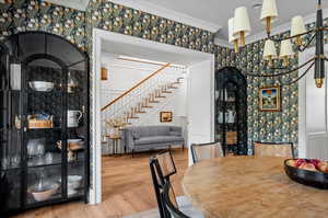 Dining area with crown molding and wood-type flooring