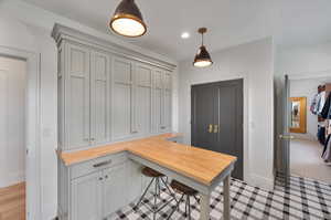 Laundry room with light hardwood / wood-style floors