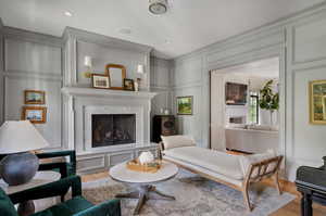 Living room with light hardwood / wood-style floors and a luxury fireplace