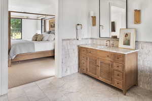 Bathroom with vanity and  carrara marble tile patterned floors