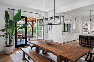 Dining space with sink, light wood-type flooring, and plenty of natural light