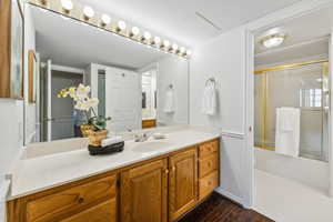 Bathroom featuring vanity and wood-type flooring