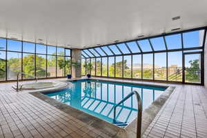 View of pool featuring an in ground hot tub and a patio