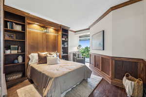 Bedroom with crown molding and dark hardwood / wood-style floors